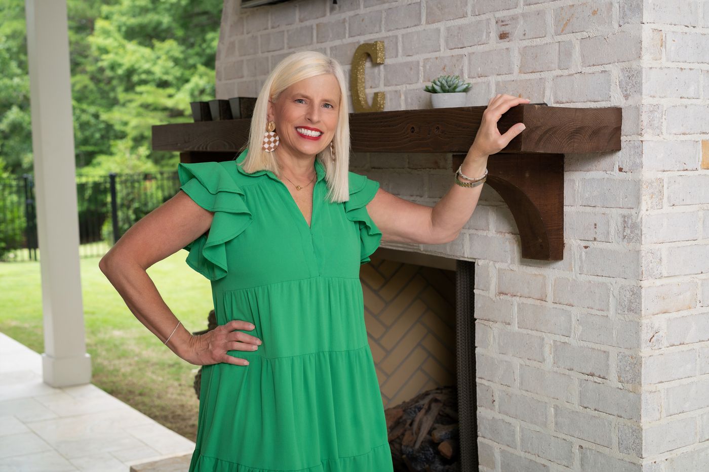 Michelle Creamer by an outdoor fireplace
